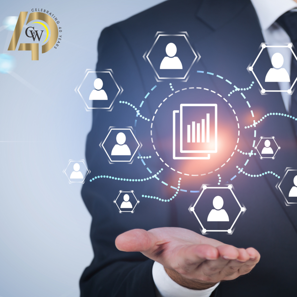 Businessman in suit extending hand showing graphic of managed IT services