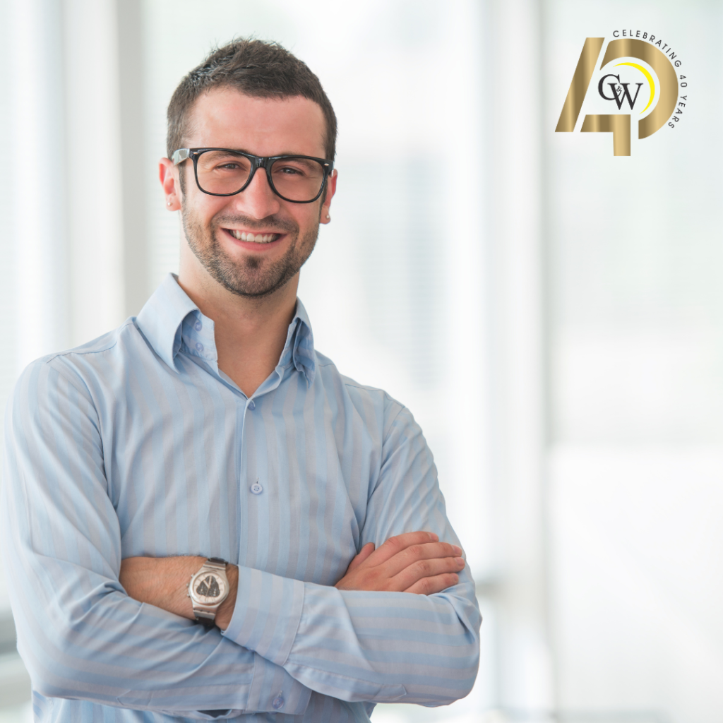 Businessman in blue shirt smiling at camera