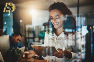 Businesswoman looking at tablet of predictions for technology in 2026
